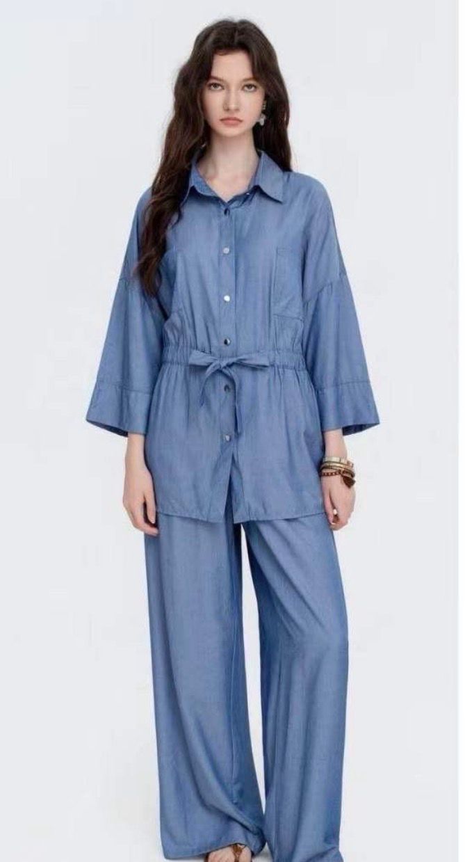 Blue denim look two-piece loungewear set with tie waist shirt and wide leg trousers. Sale price £