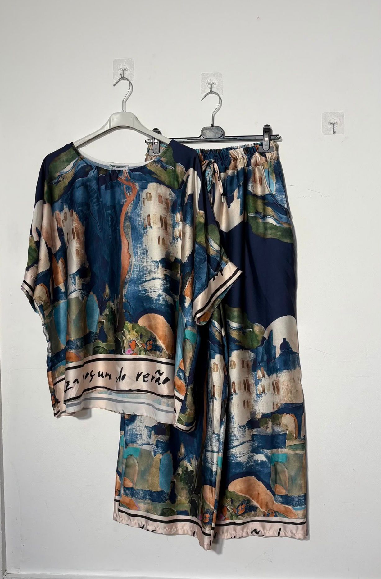 Women’s satin abstract-print two-piece set with a relaxed top and matching wide-leg trousers.

