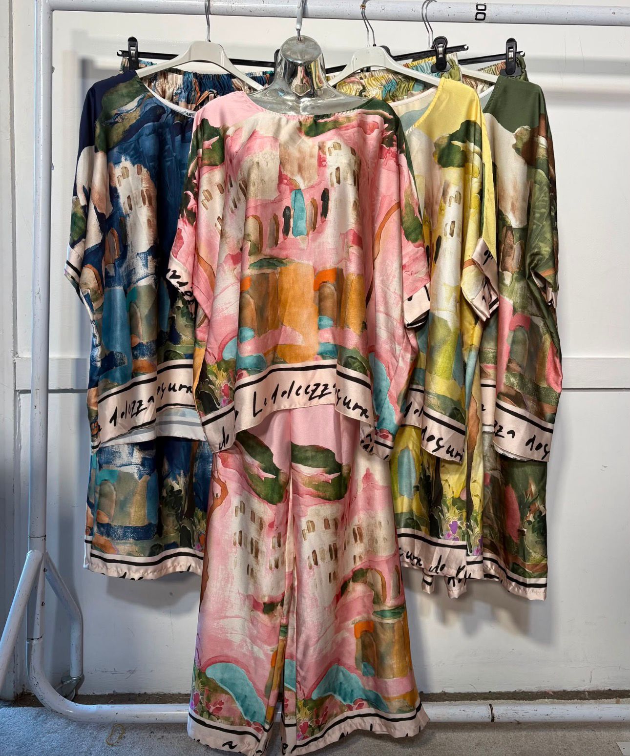 Women’s satin abstract-print two-piece set with a relaxed top and matching wide-leg trousers.
