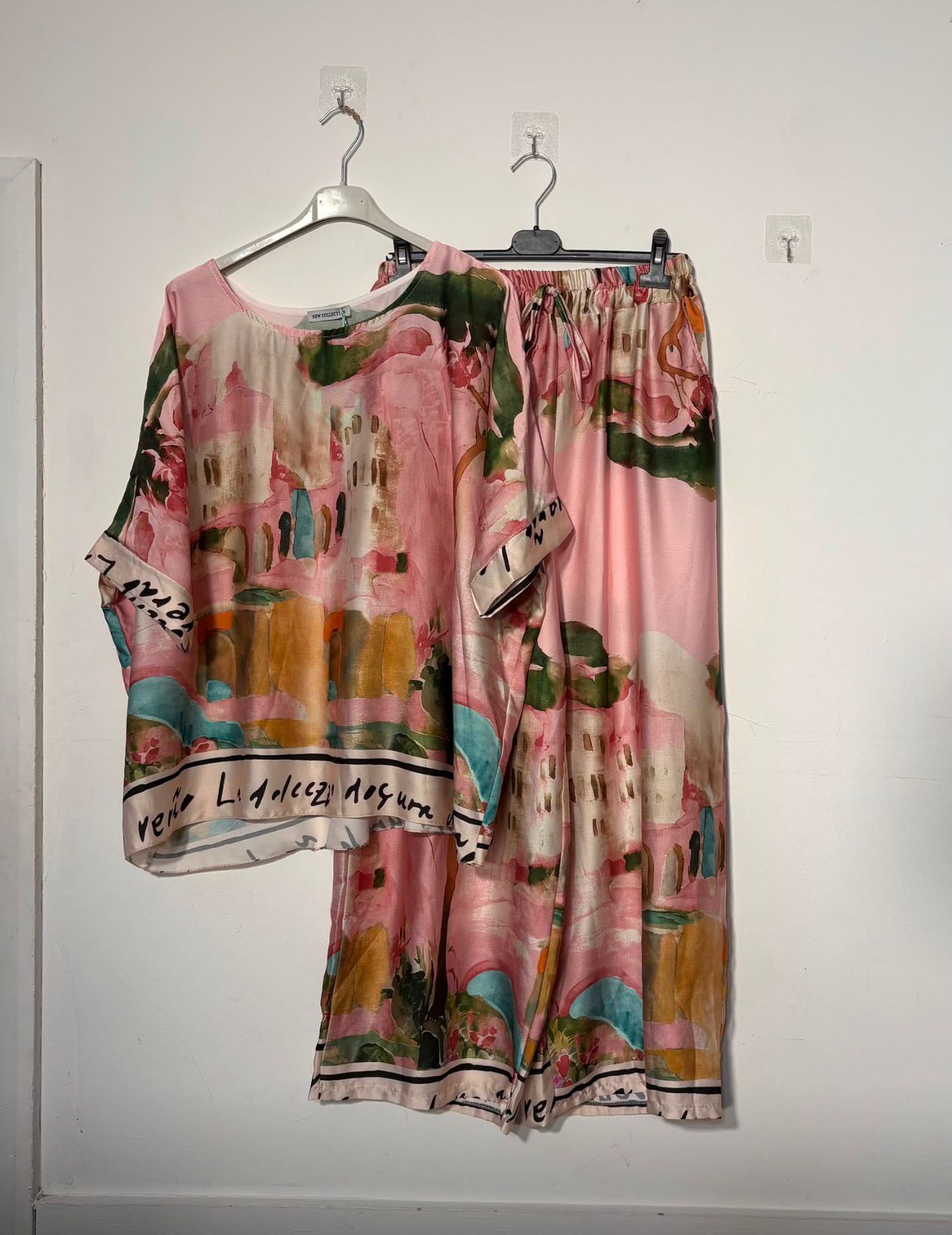 Women’s satin abstract-print two-piece set with a relaxed top and matching wide-leg trousers.
