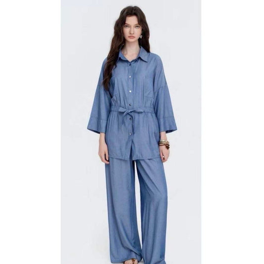 Blue denim look two-piece loungewear set with tie waist shirt and wide leg trousers. Sale price £