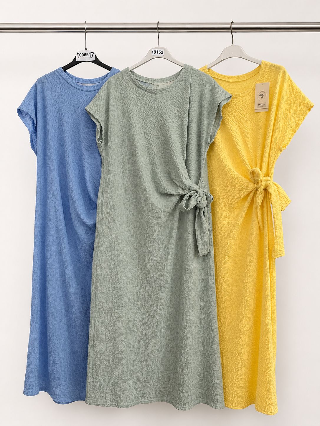 Waffle side tie dress with flattering side tie detail in blue, sage green and yellow. Soft stretchy textured fabric. One size fits up to UK 18.
