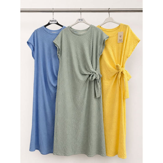 Waffle side tie dress with flattering side tie detail in blue, sage green and yellow. Soft stretchy textured fabric. One size fits up to UK 18.
