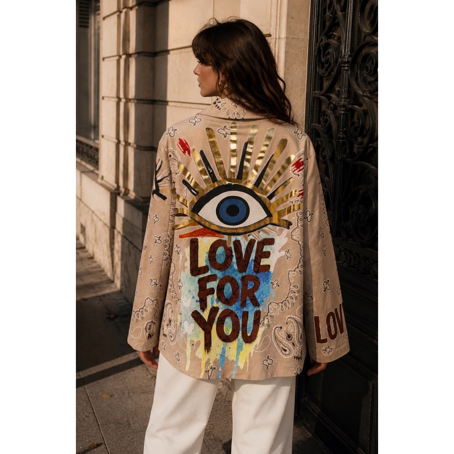 Beige graffiti print statement blazer with paisley design and colourful artwork on the front and back.
