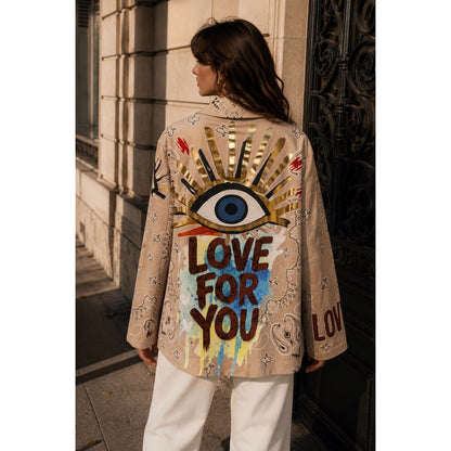 Beige graffiti print statement blazer with paisley design and colourful artwork on the front and back.
